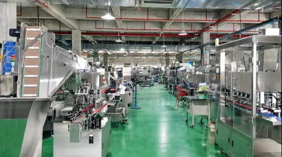 Assembled packaging equipment and conveyors along a workshop aisle